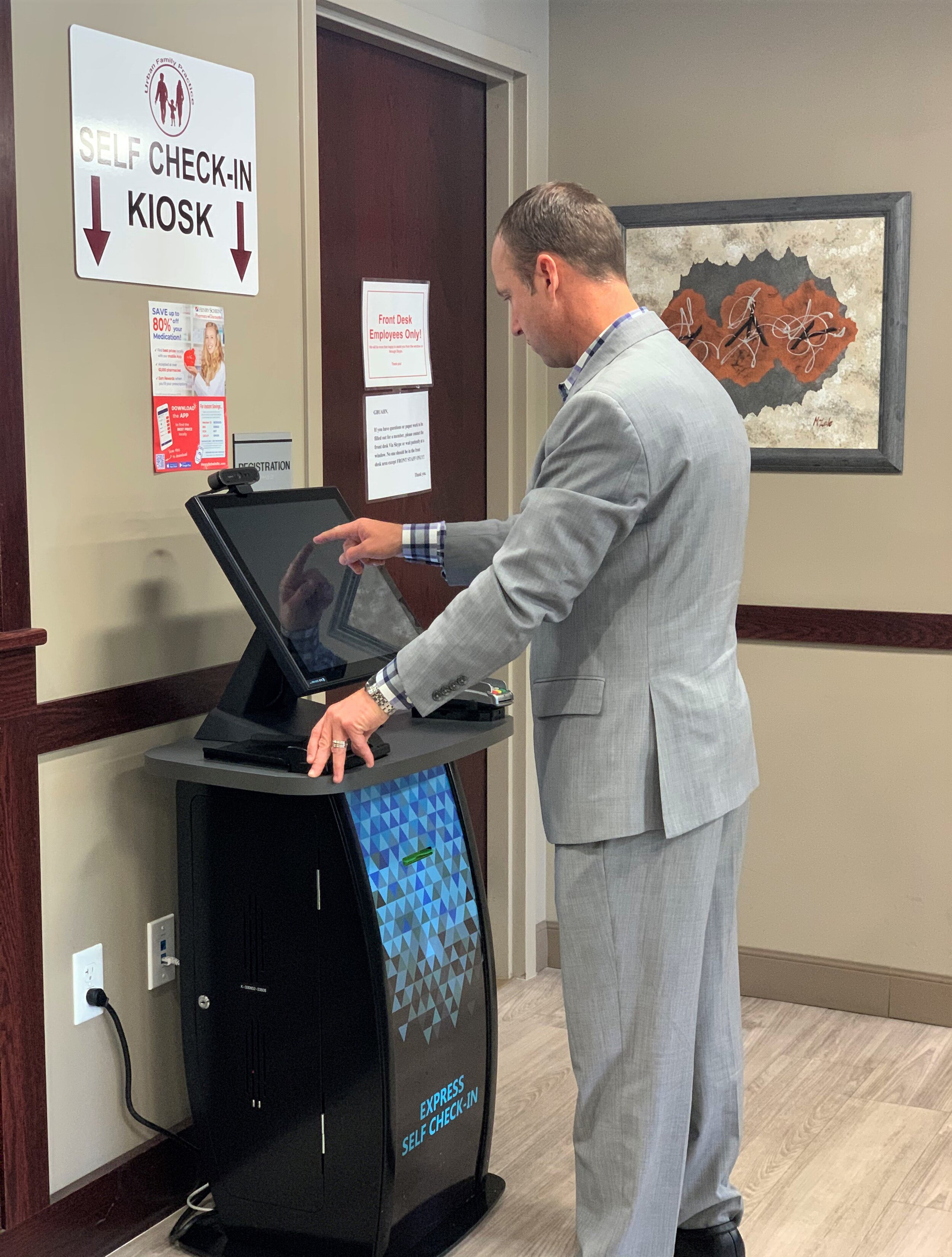  Jason Isbrandt, Director of Strategic Physician Partnerships for G-Health Enterprises, demonstrates the efficiency of a MEDENT self-check-in kiosk at GBUAHN in Buffalo, New York. 